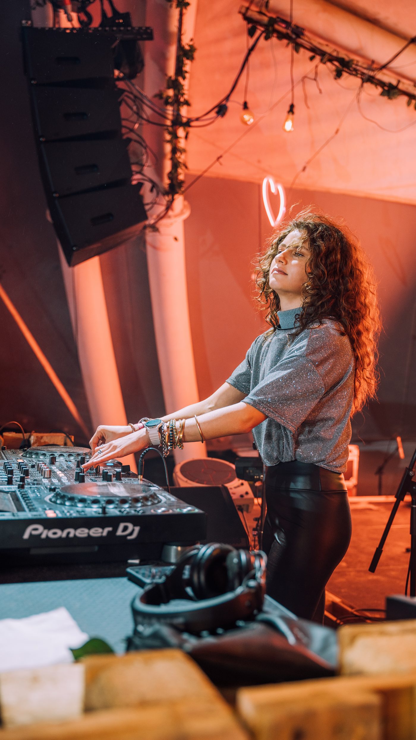 M!A LI'EL performing behind Pioneer decks in amber stage light